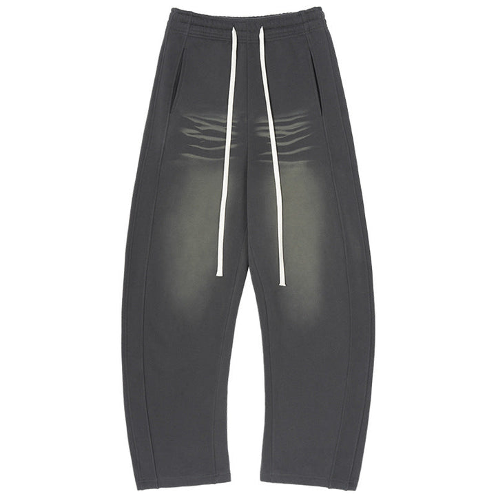 Men's baggy sweatpants with low crotch, contrasting decorative seams, and extra long drawstrings.