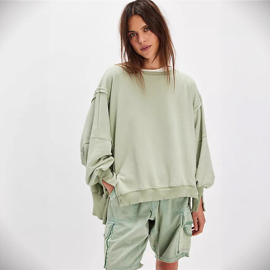 Women's oversized sweatshirt with balloon sleeves, open seam stitches, and side slits Hudson & Parker