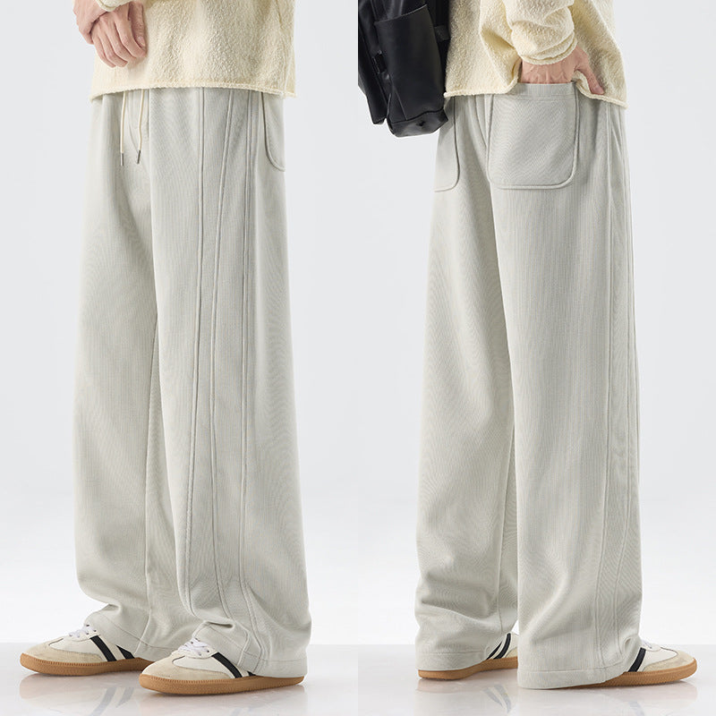 Men's loose sweatpants with decorative seam piping and drawstring