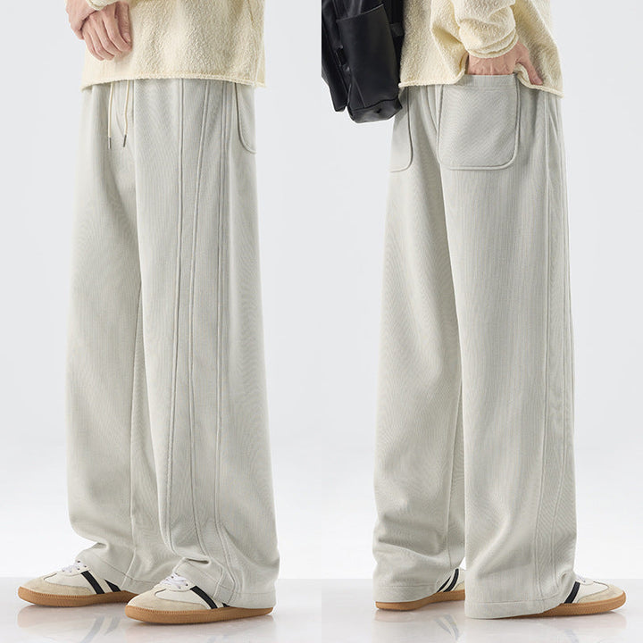 Men's loose sweatpants with decorative seam piping and drawstring