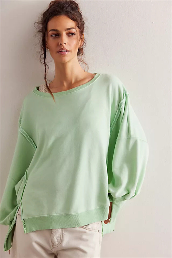 Women's oversized sweatshirt with balloon sleeves, open seam stitches, and side slits Hudson & Parker