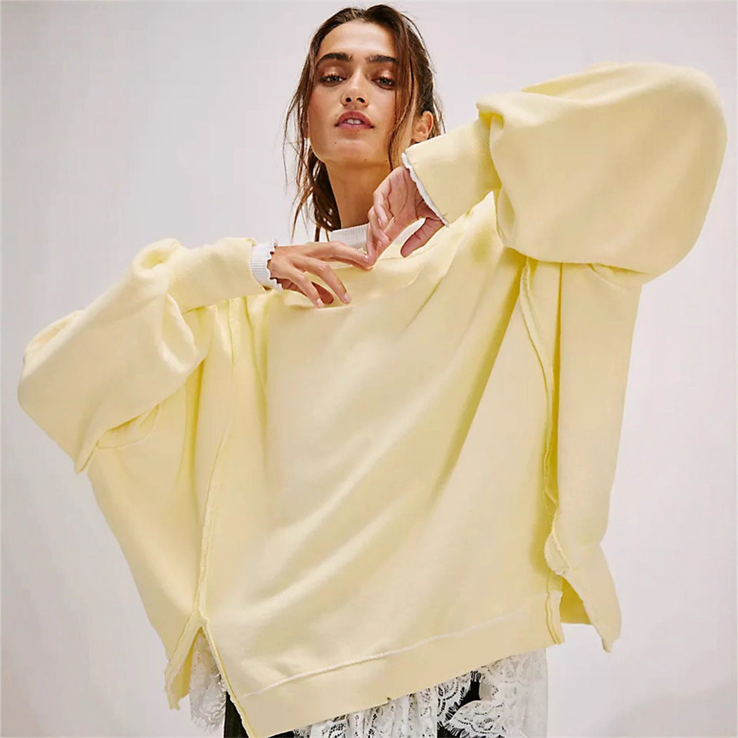 Women's oversized sweatshirt with balloon sleeves, open seam stitches, and side slits Hudson & Parker