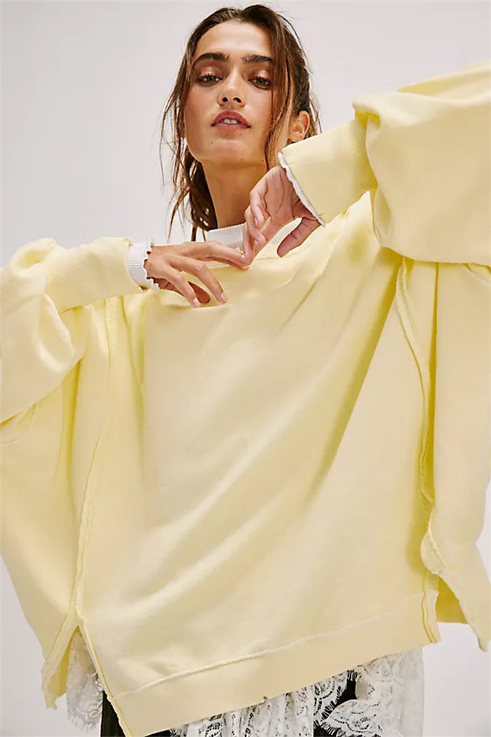 Women's oversized sweatshirt with balloon sleeves, open seam stitches, and side slits Hudson & Parker