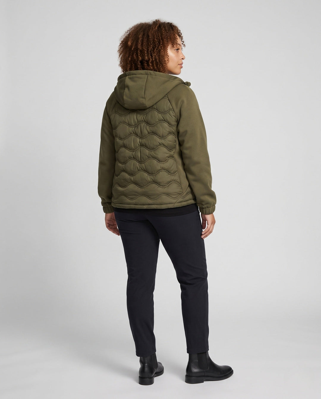 Women's quilted hybrid hoodie jacket with fleece sleeves, elastic cuffs, and wave quilting