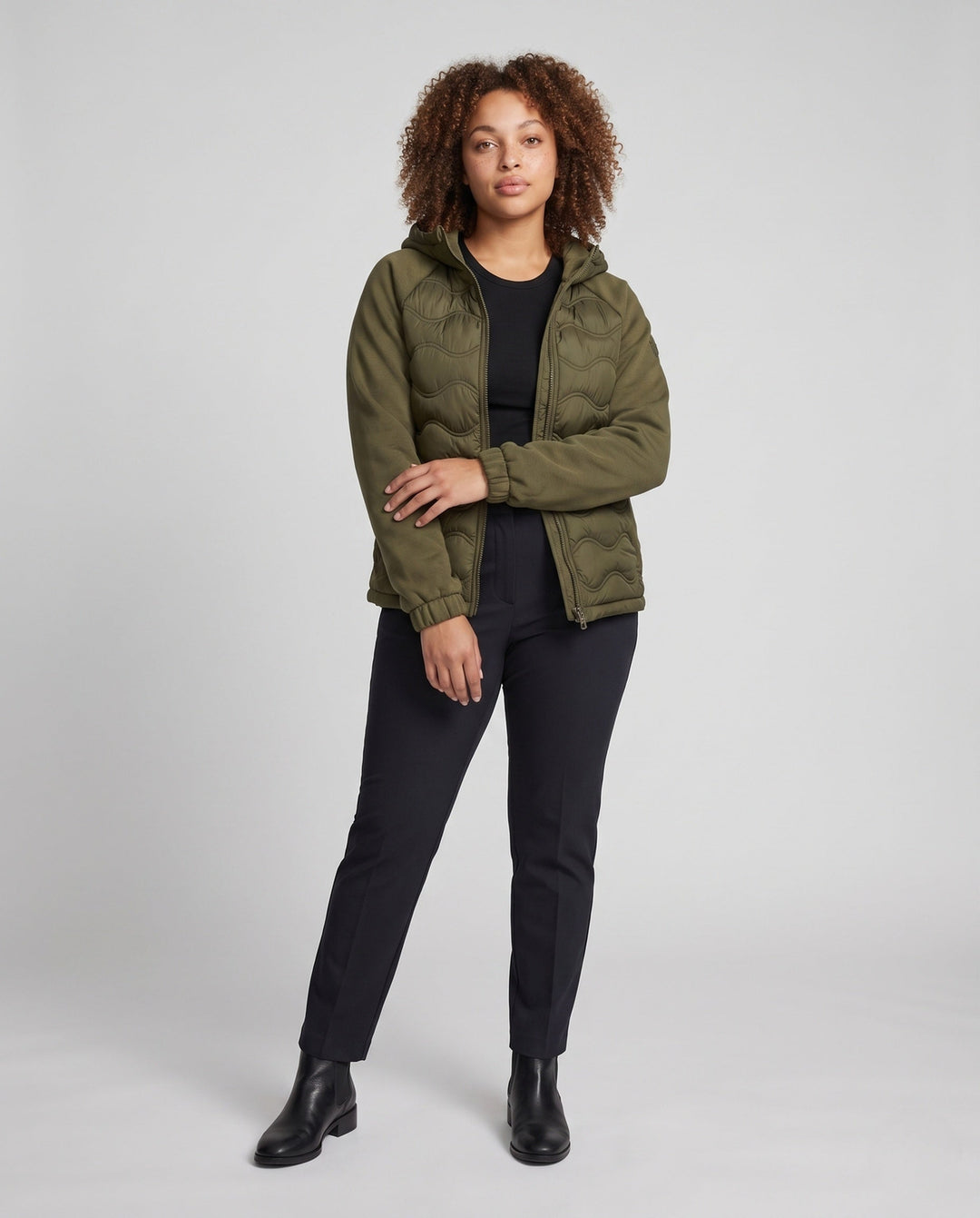Women's quilted hybrid hoodie jacket with fleece sleeves, elastic cuffs, and wave quilting