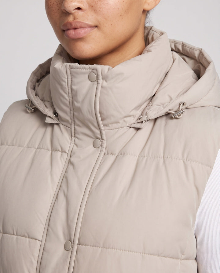 Women’s padded hooded vest with waistbelt and high collar