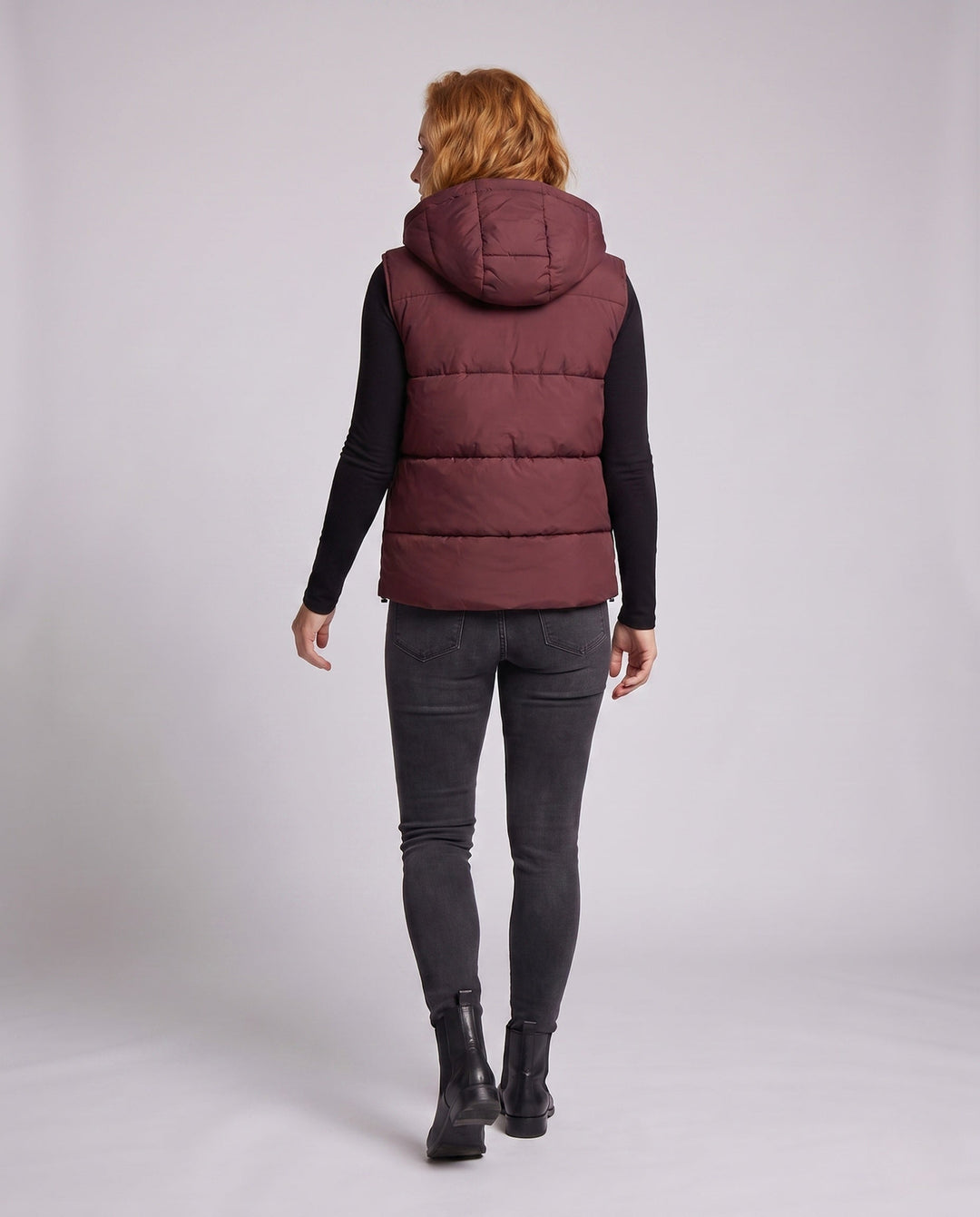 Women's padded hooded vest with thermal lining, adjustable hood and slanted pockets