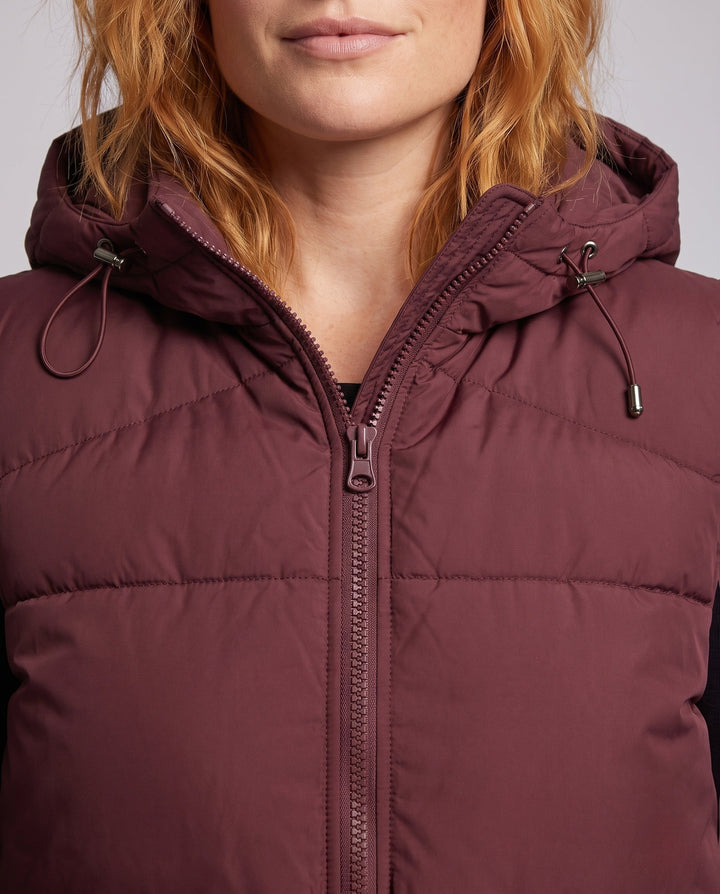 Women's padded hooded vest with thermal lining, adjustable hood and slanted pockets