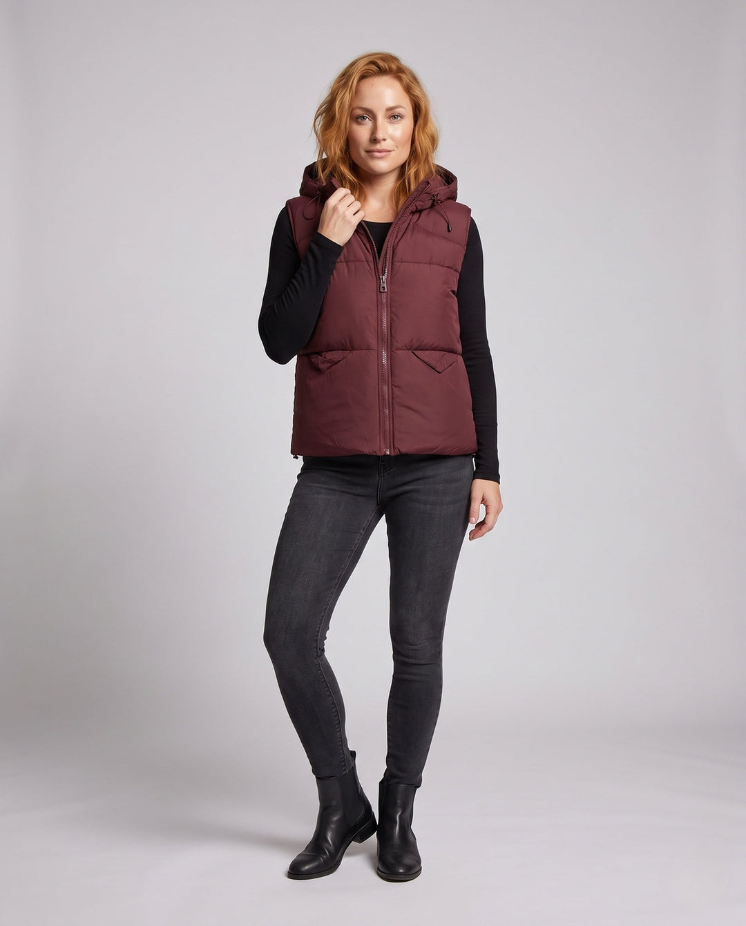 Women's padded hooded vest with thermal lining, adjustable hood and slanted pockets