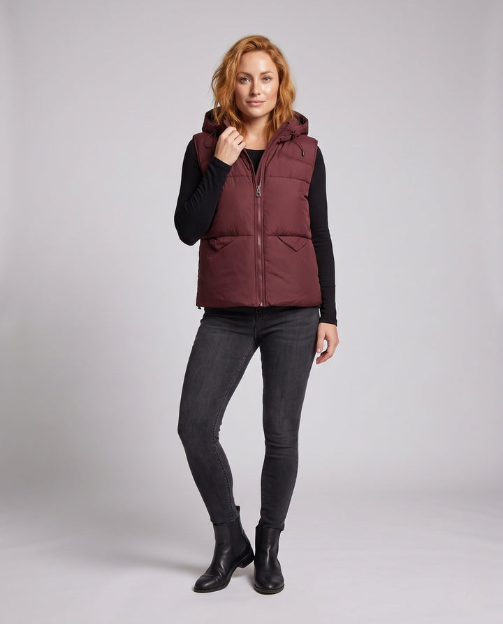 Women's padded hooded vest with thermal lining, adjustable hood and slanted pockets