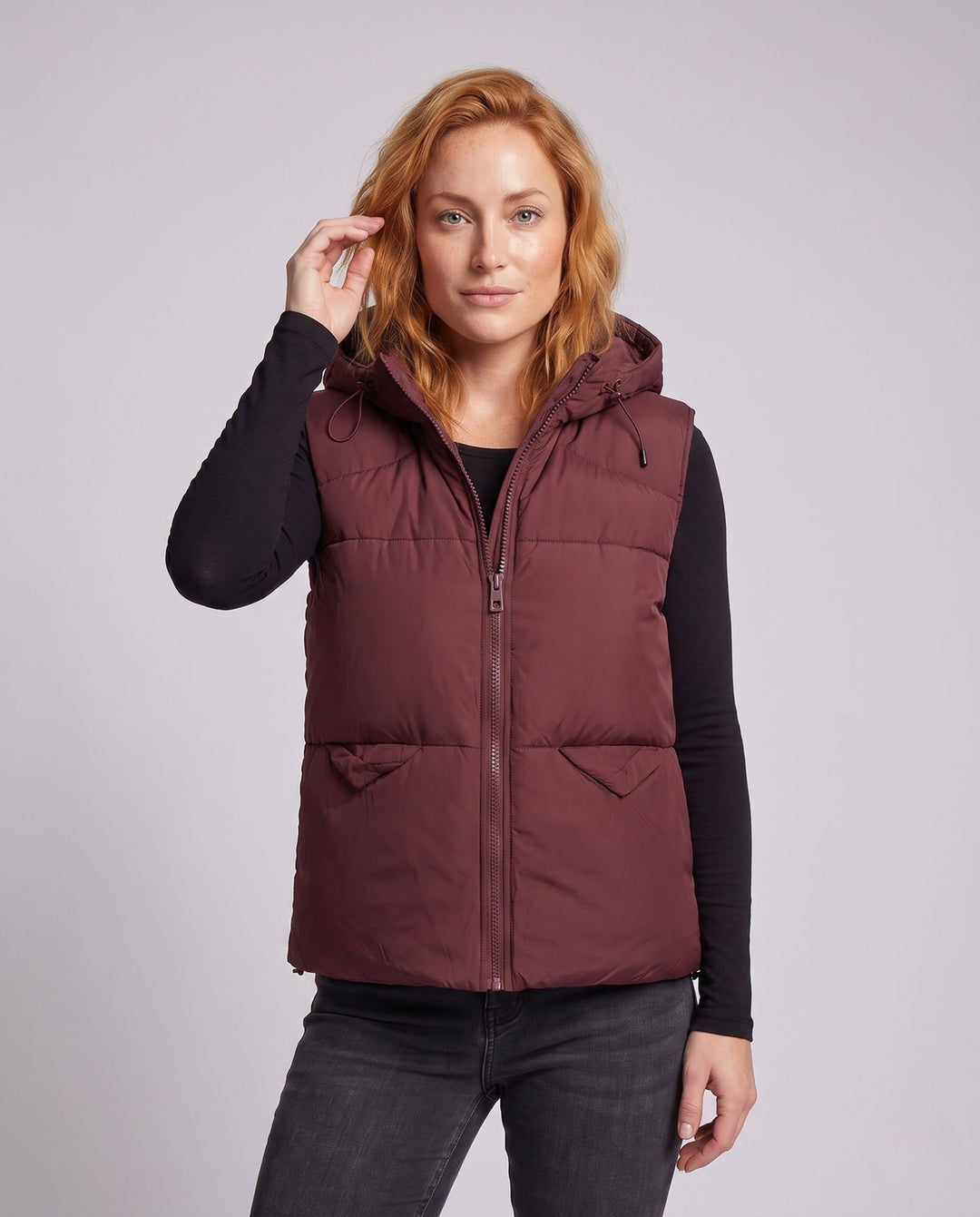 Women's padded hooded vest with thermal lining, adjustable hood and slanted pockets