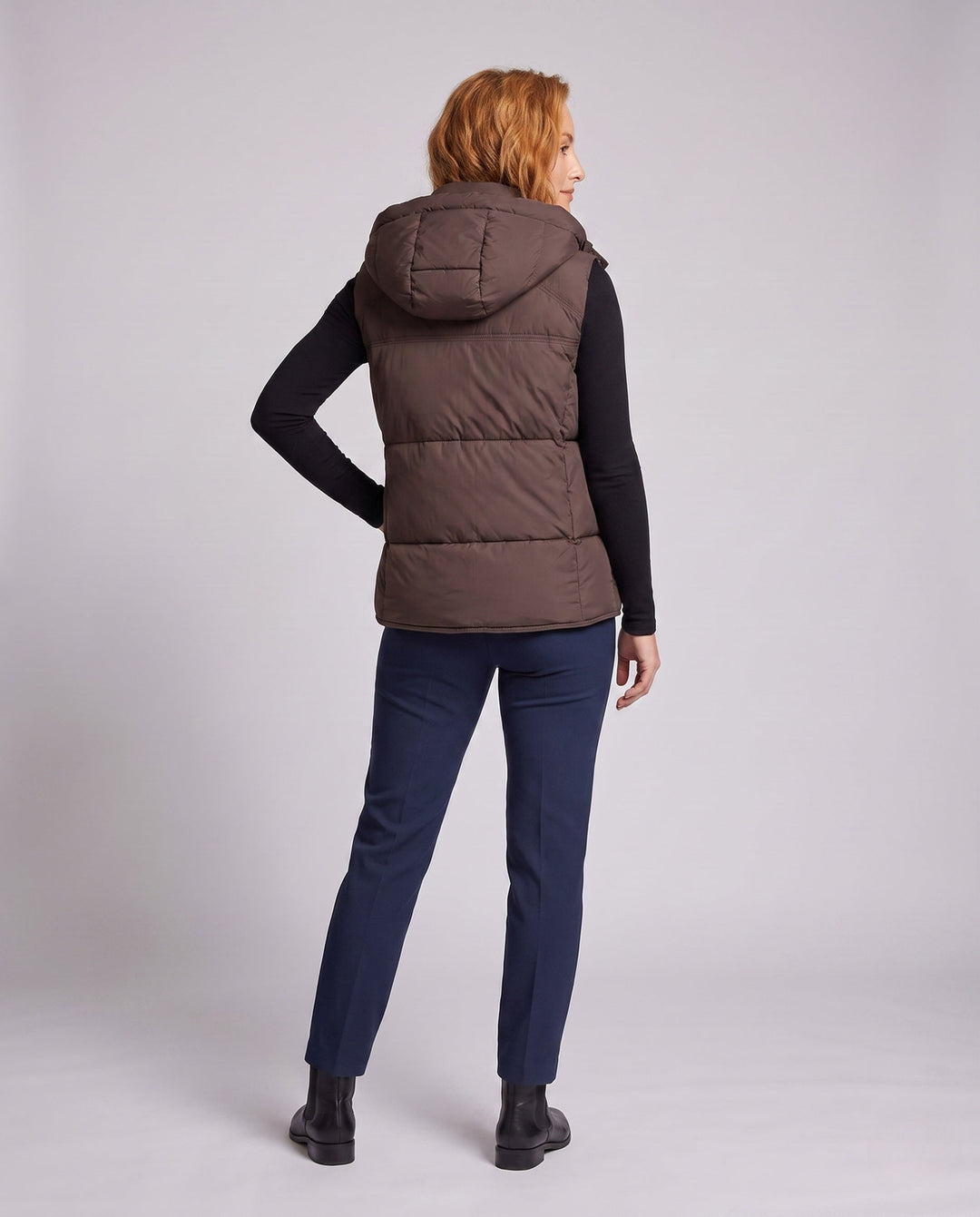 Women's padded hooded vest with voluminous thermal filling and high-closing shawl collar