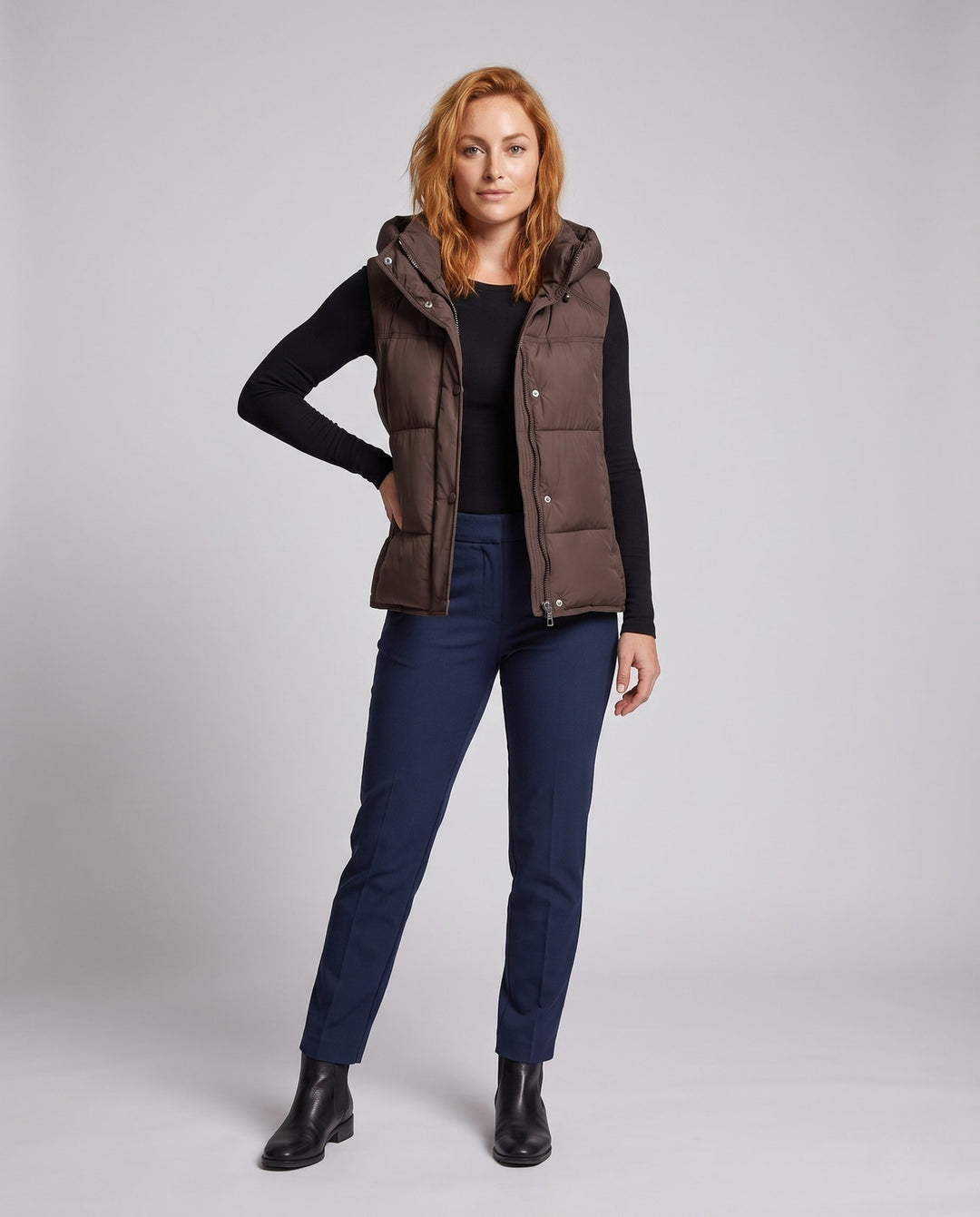 Women's padded hooded vest with voluminous thermal filling and high-closing shawl collar