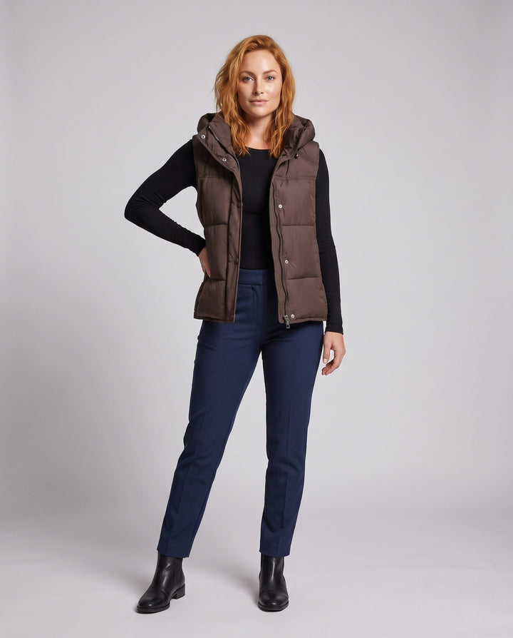 Women's padded hooded vest with voluminous thermal filling and high-closing shawl collar