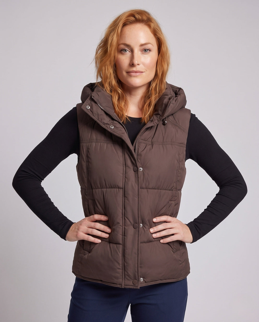 Women's padded hooded vest with voluminous thermal filling and high-closing shawl collar