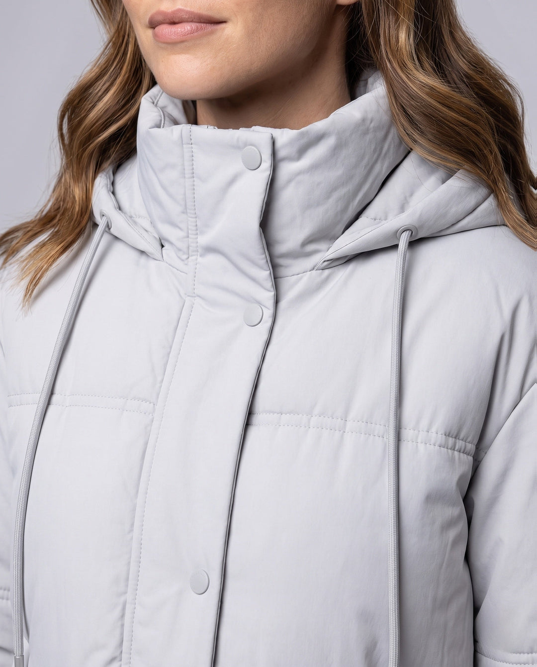 Women's short quilted hooded blouse with teddy inner collar, concealed two-way zipper, and adjustable hem