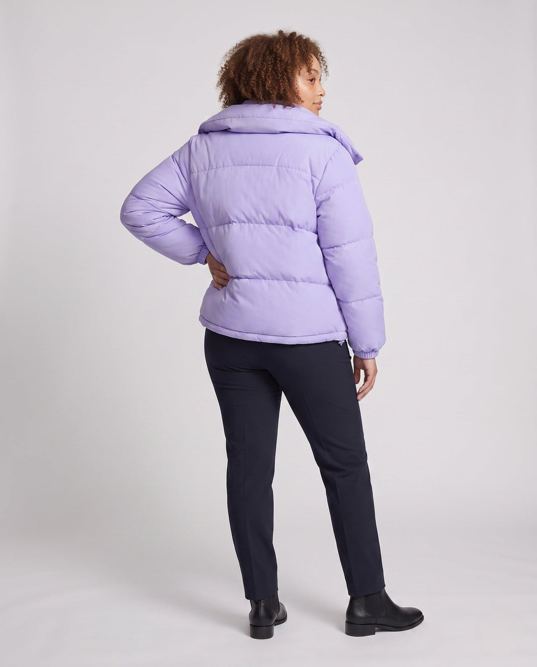 Ladies' short padded hooded puffer with oversized hood, flap pockets, and adjustable hem
