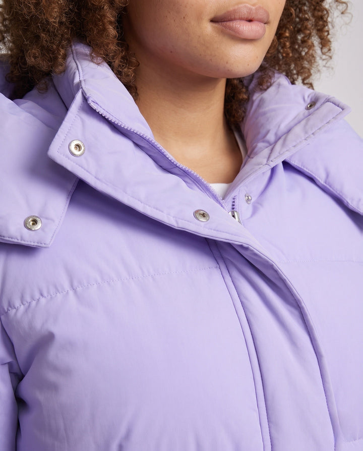 Ladies' short padded hooded puffer with oversized hood, flap pockets, and adjustable hem