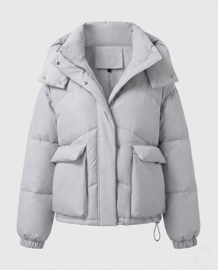 Ladies' short padded hooded puffer with oversized hood, flap pockets, and adjustable hem