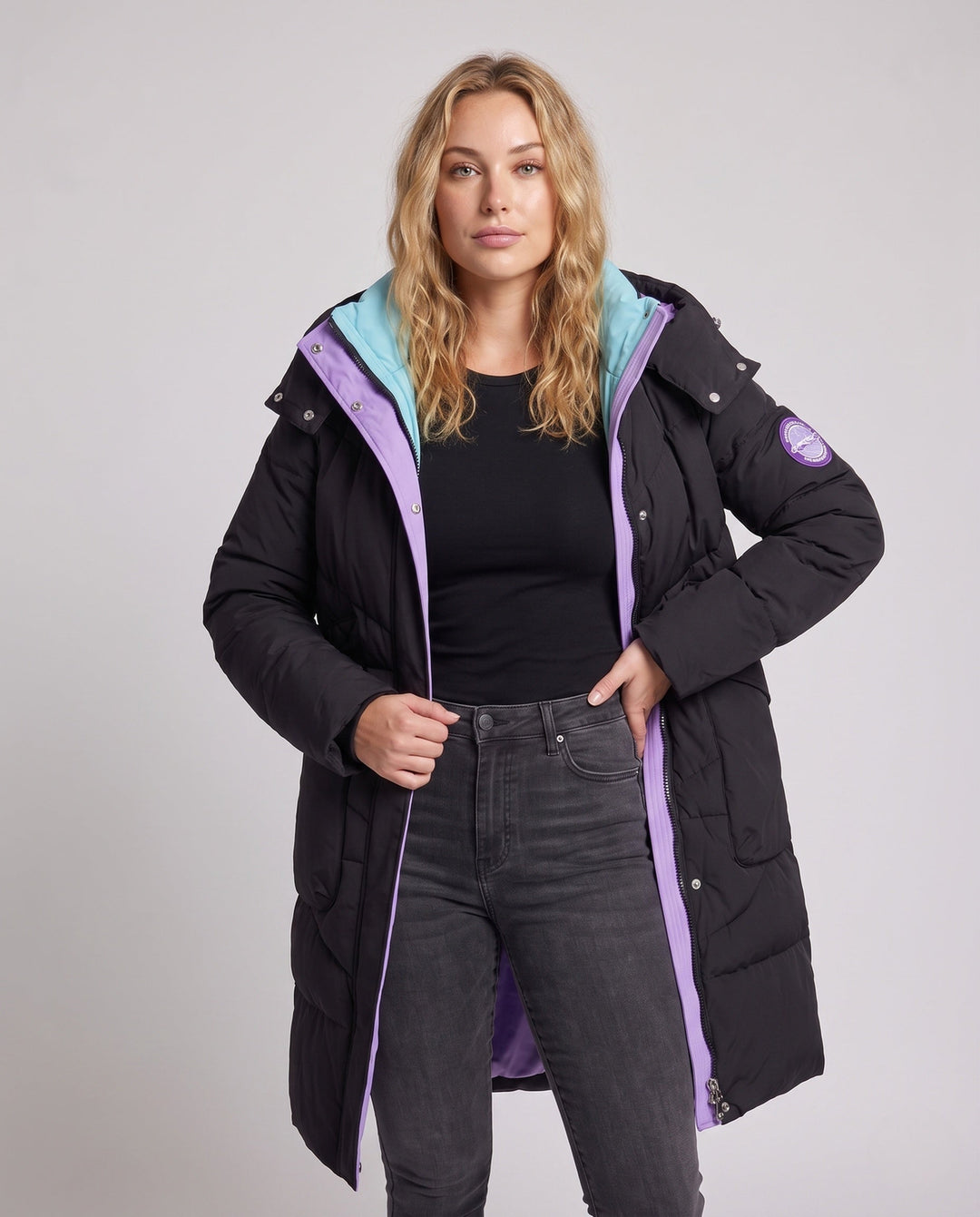 Women's longer padded hooded coat with large flap and patch pocket as well as elastic cuffs