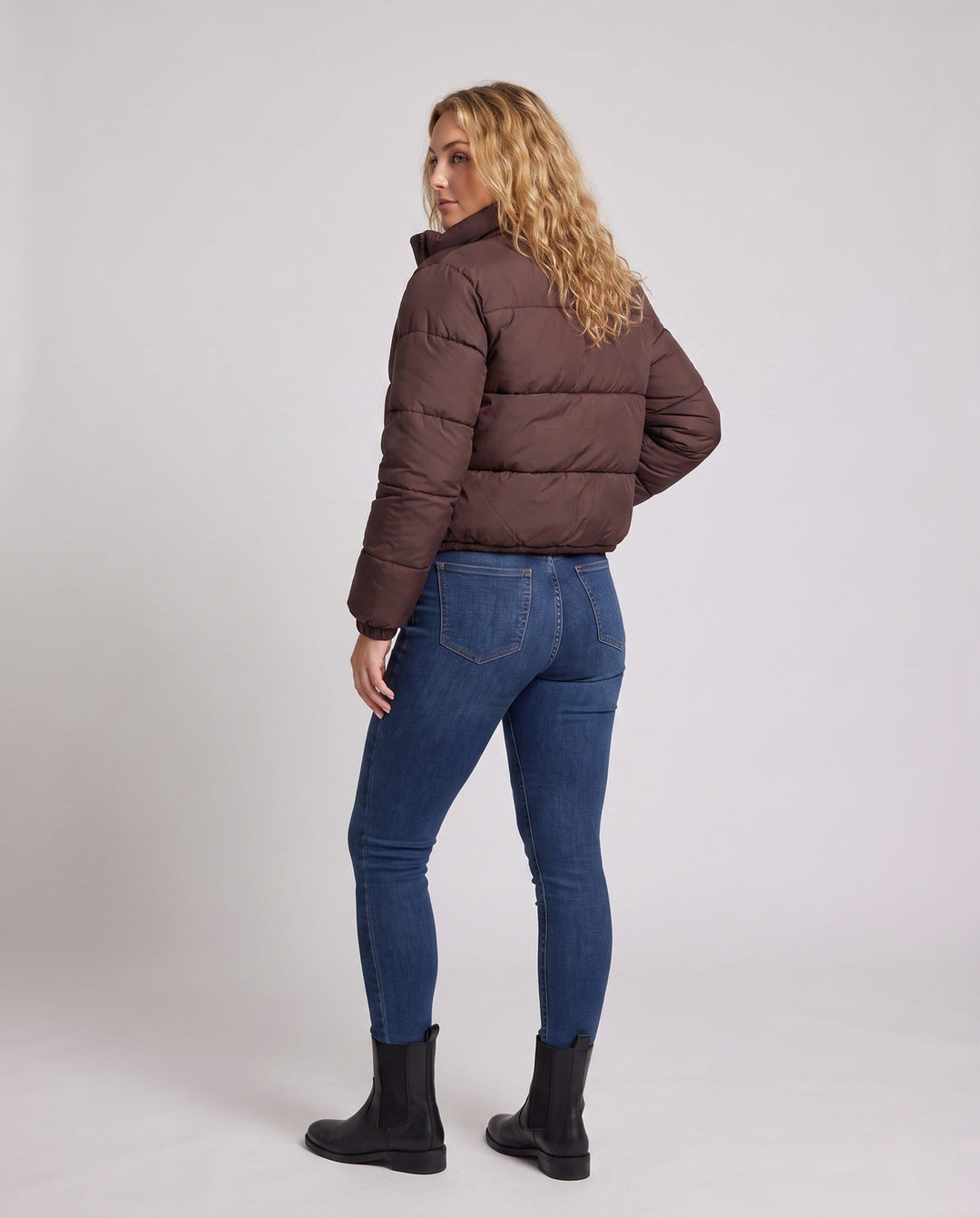 Women's ultra-lightweight hoodless oversized puffer with high standing collar, silent outer shell, and thermally insulating padding