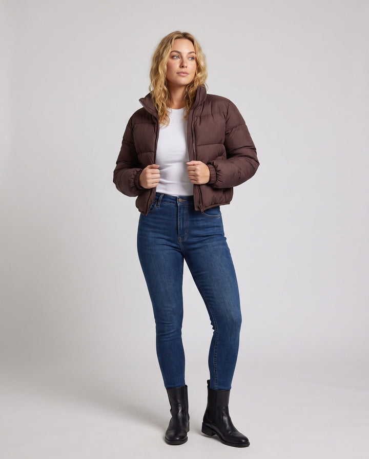 Women's ultra-lightweight hoodless oversized puffer with high standing collar, silent outer shell, and thermally insulating padding