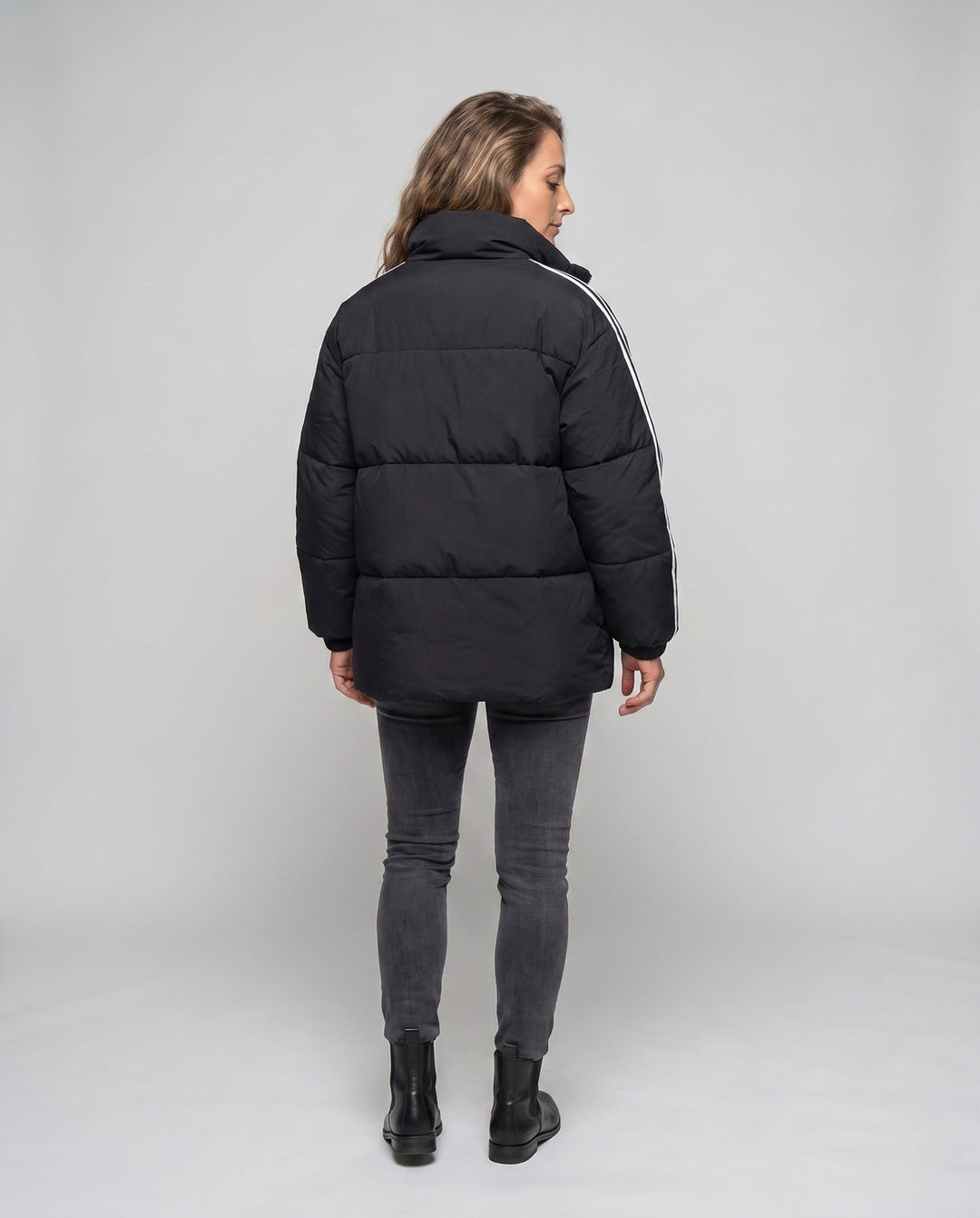 Unisex oversized quilted jacket with contrast stripes on sleeves, high-closing collar, and hood placket