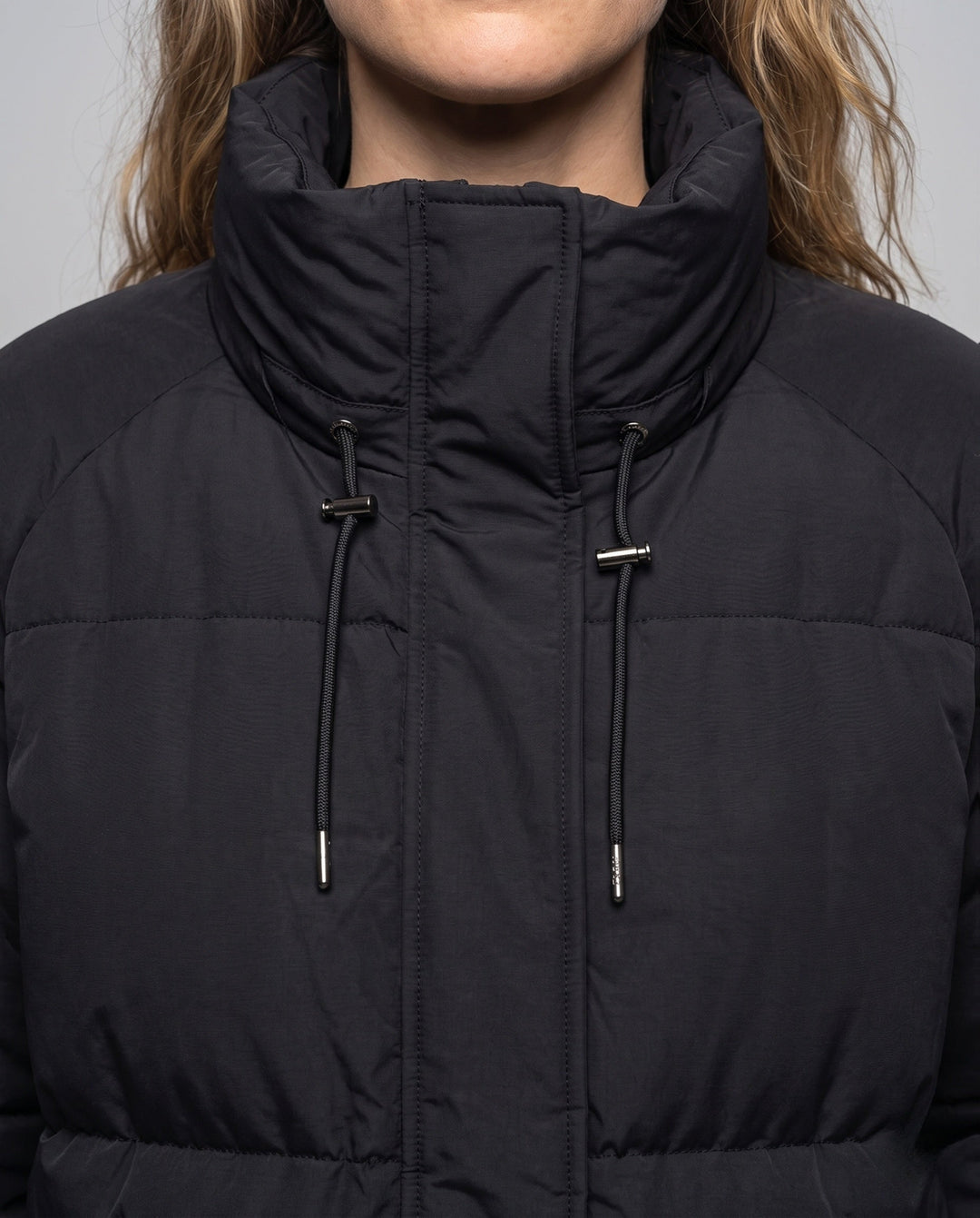 Unisex oversized quilted jacket with contrast stripes on sleeves, high-closing collar, and hood placket