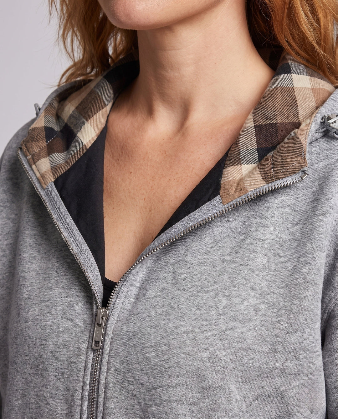 Women's oversized hoodie jacket with checked hood lining, elastic hem, and concealed side pockets