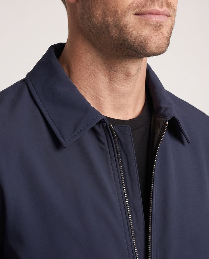 Men's quilted down jacket with minimalist outer shell and stand-up collar