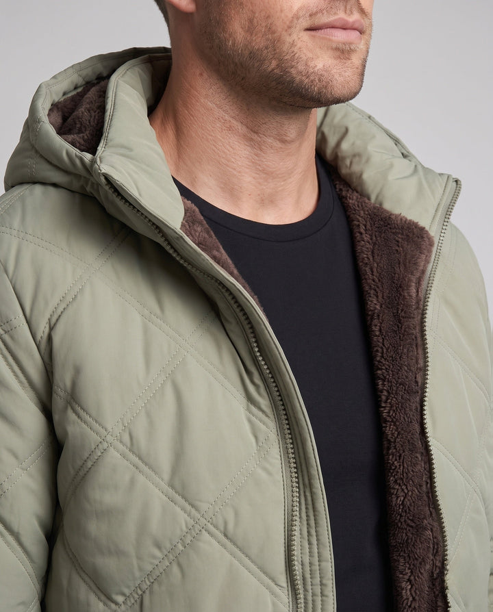 Men's quilted hooded jacket with thick teddy lining, diamond quilting, and windproof outer membrane