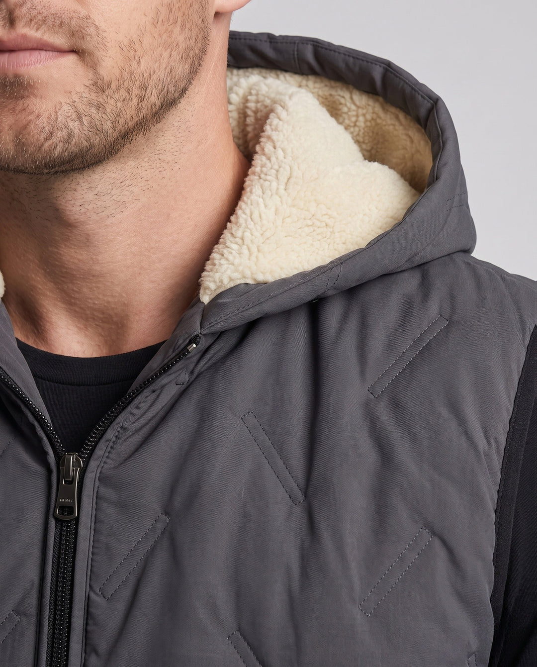 Men's quilted hooded vest with warming Sherpa lining and concealed zip pockets