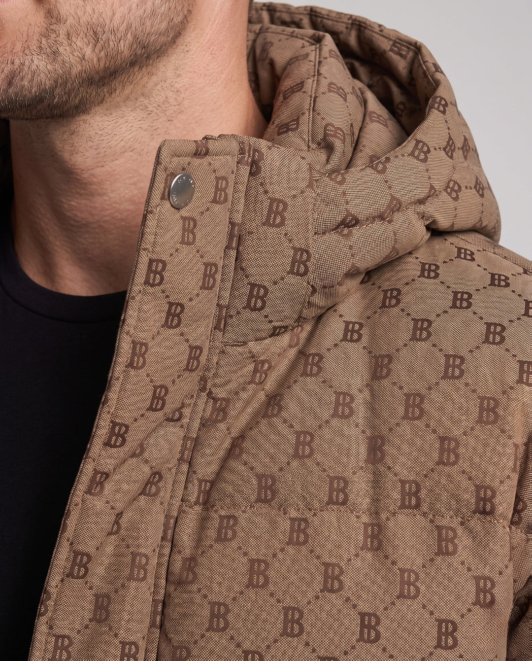Men's quilted oversized parka with hood, allover monogram, snap button placket, and large patch pockets