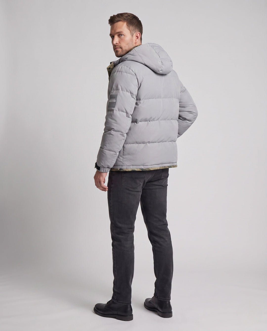 Men's short thermal quilted parka with hood, applied flap pockets, concealed front placket, and camouflage-lined interior