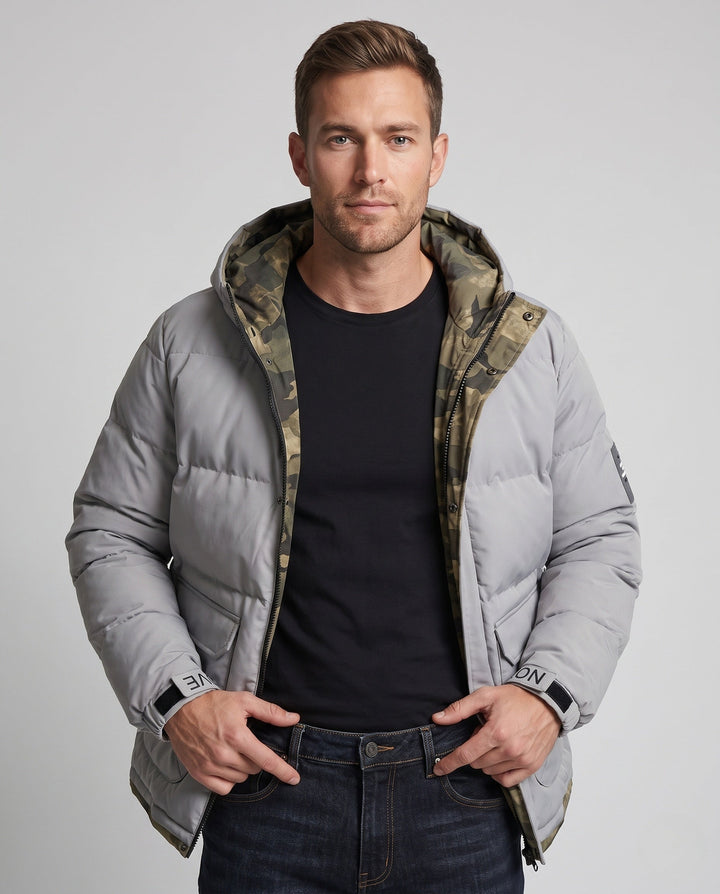 Men's short thermal quilted parka with hood, applied flap pockets, concealed front placket, and camouflage-lined interior