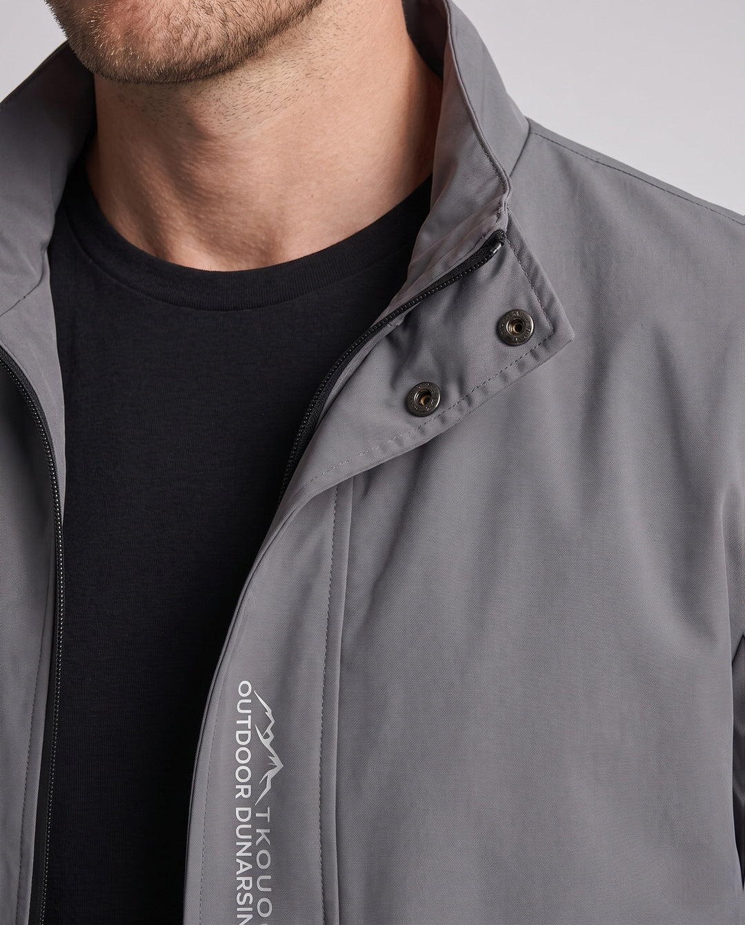 Men's lightweight microfiber windbreaker with stand-up collar, water-repellent surface, and concealed pockets