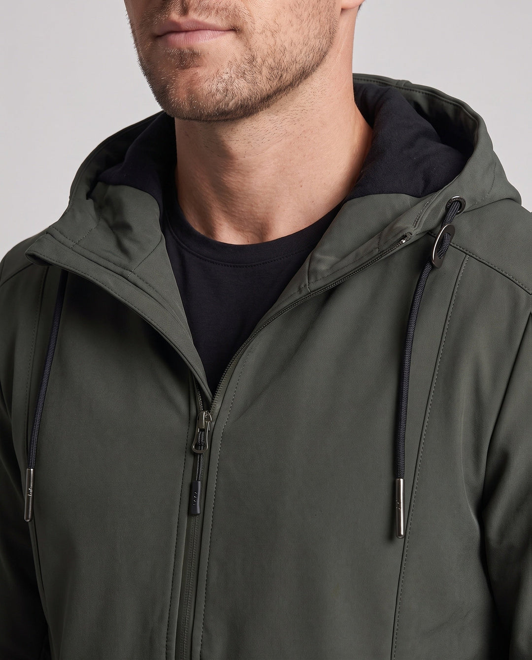 Men's lightweight softshell parka with hood, wind-resistant surface, hidden zipper, and flap pockets