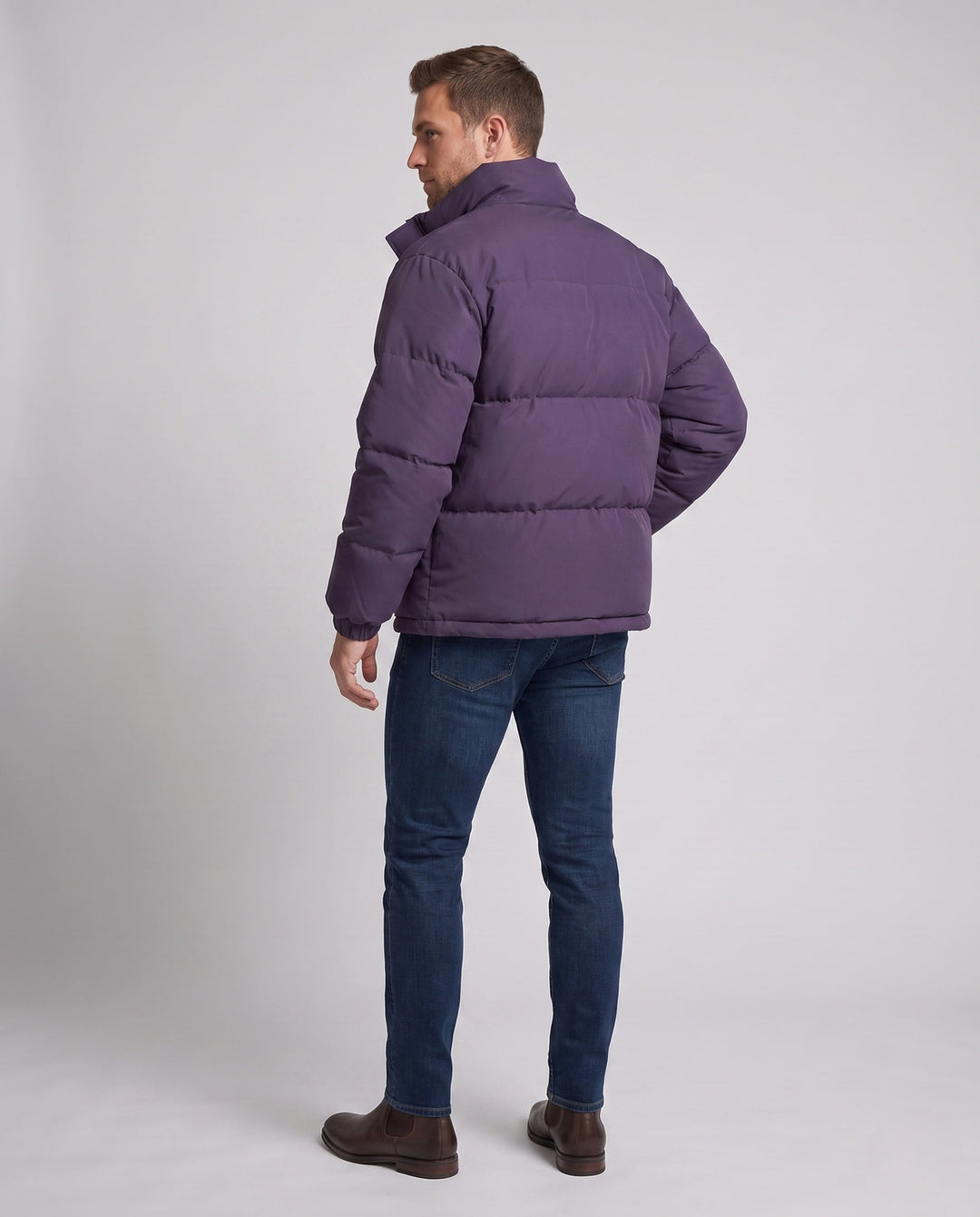 Men's minimalist thermal puffer jacket with high stand-up collar, internal wind protection, and elastic hem