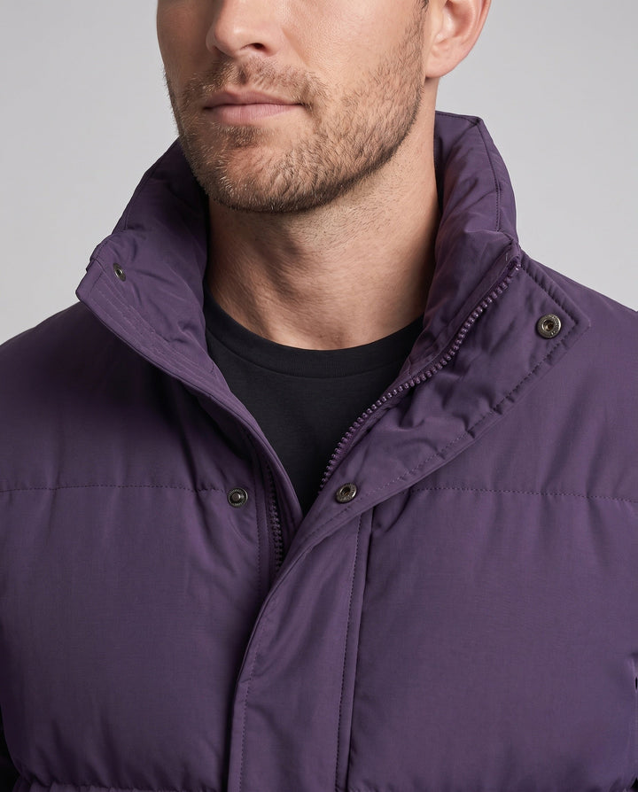 Men's minimalist thermal puffer jacket with high stand-up collar, internal wind protection, and elastic hem