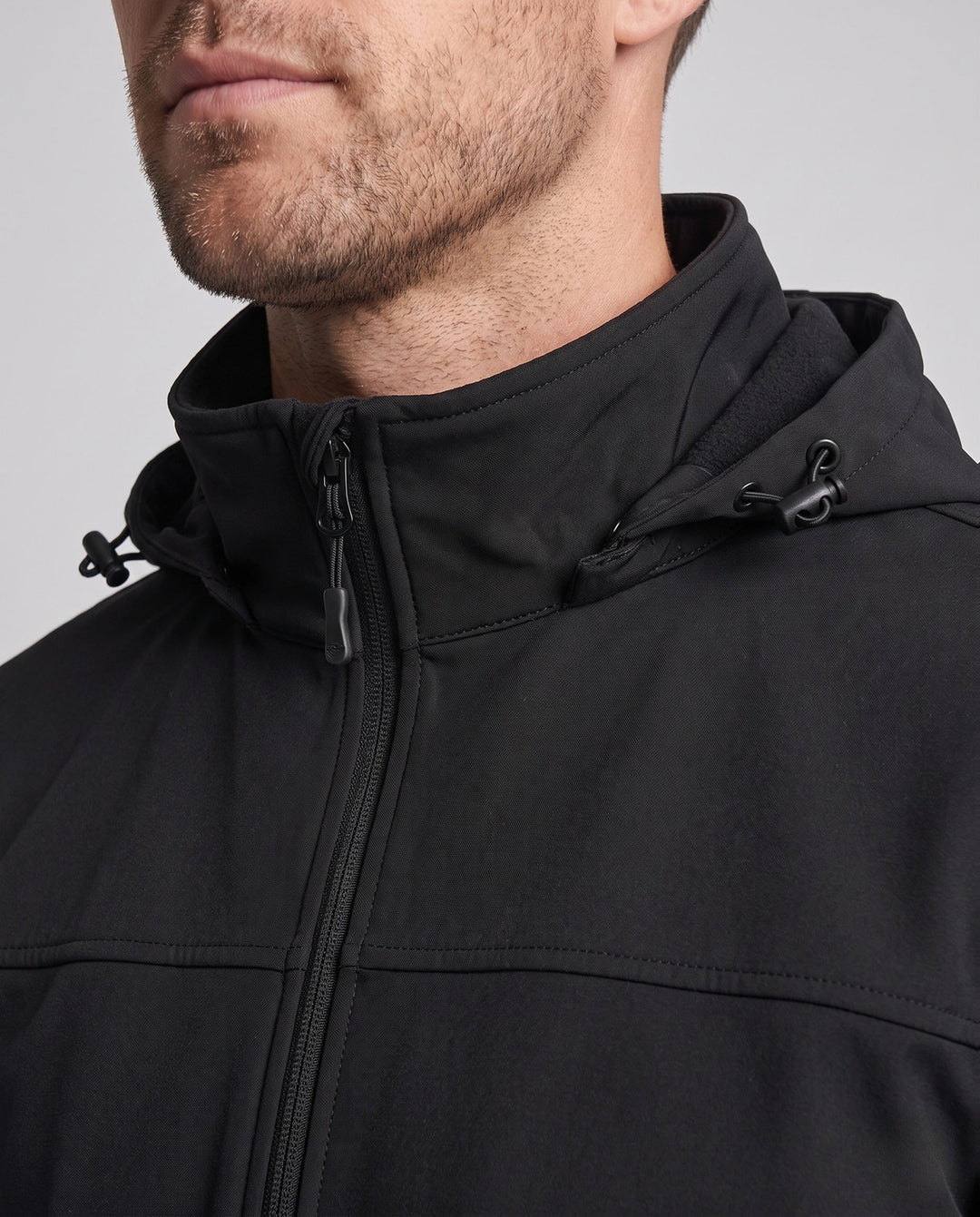 Men's technical softshell hoodie jacket with windproof membrane, adjustable hood and concealed zip pockets