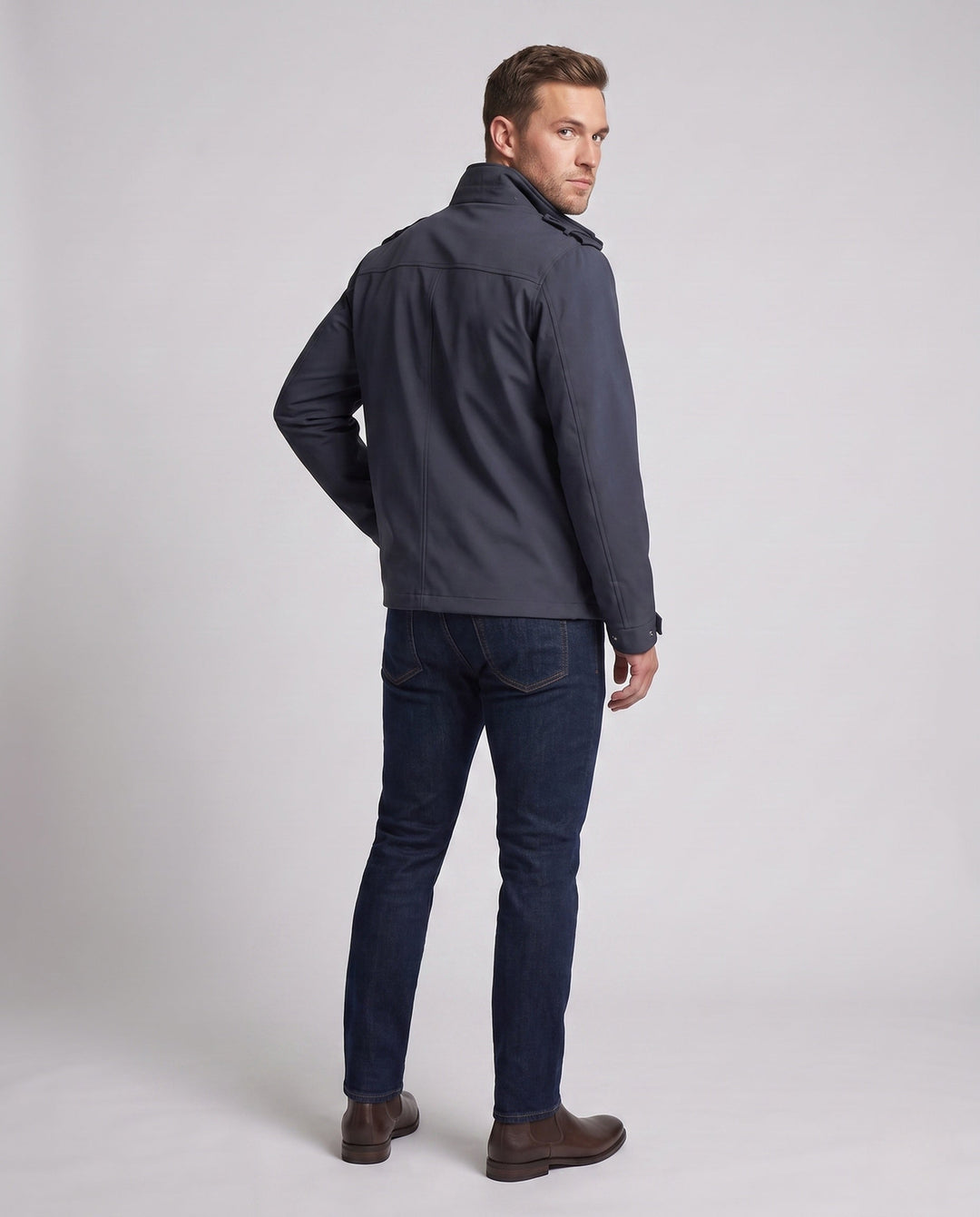 Men's urban functional jacket with concealed front flap, contrasting piping, and adjustable hem