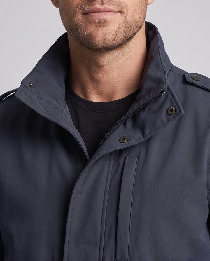 Men's urban functional jacket with concealed front flap, contrasting piping, and adjustable hem
