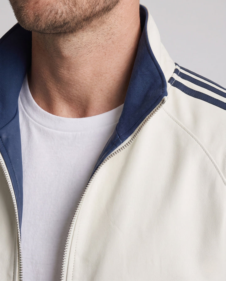 Unisex reversible sports jacket with reversible design, stand-up collar, full-length zipper, and distinctive sleeve stripes