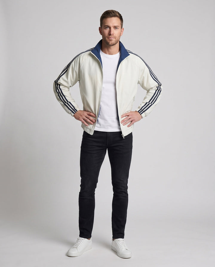 Unisex reversible sports jacket with reversible design, stand-up collar, full-length zipper, and distinctive sleeve stripes