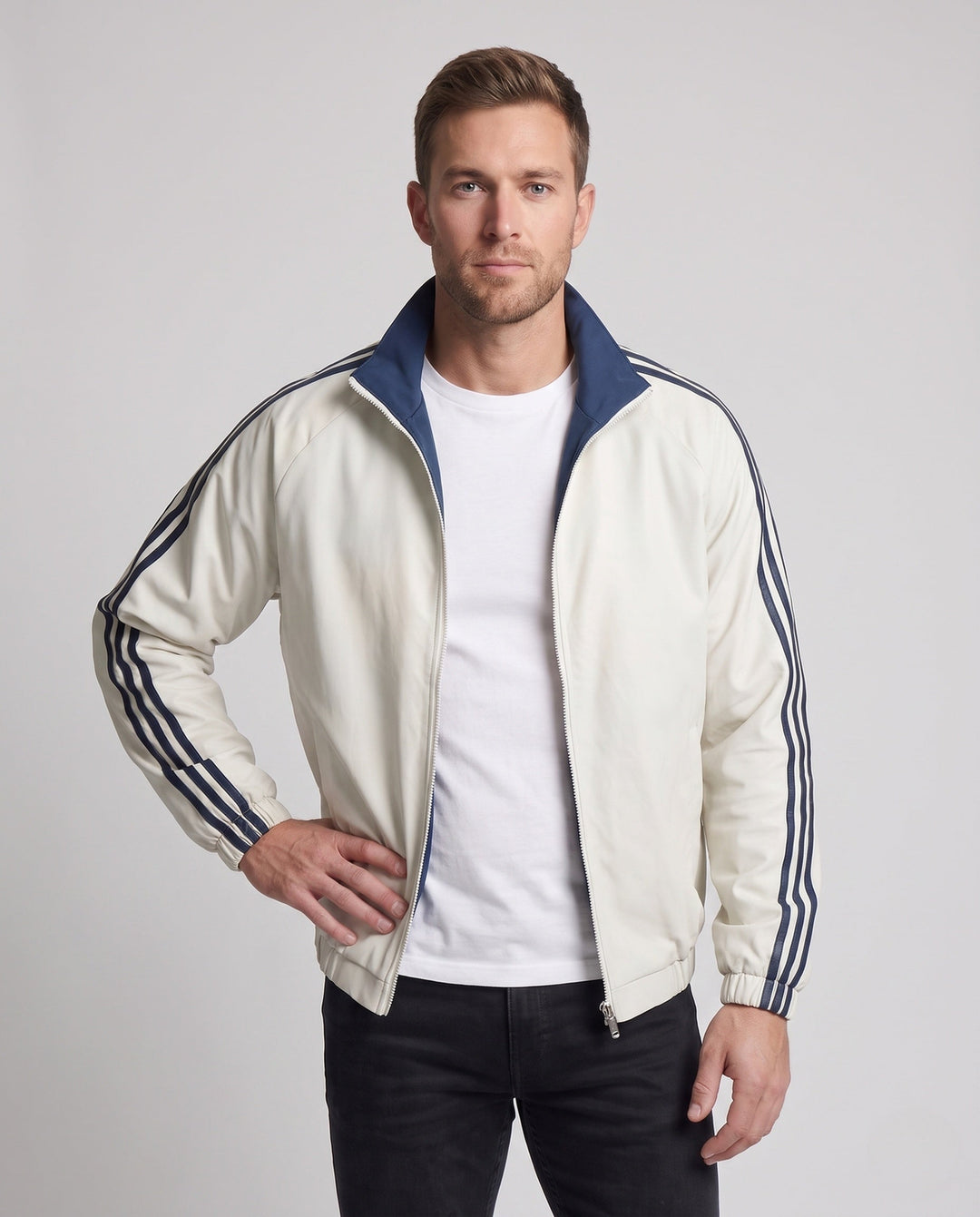 Unisex reversible sports jacket with reversible design, stand-up collar, full-length zipper, and distinctive sleeve stripes