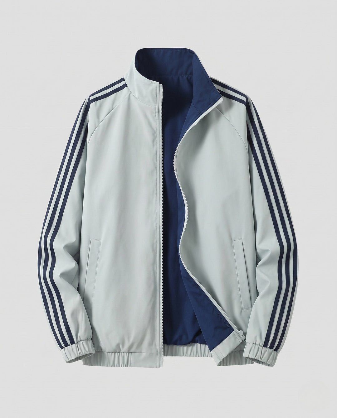 Unisex reversible sports jacket with reversible design, stand-up collar, full-length zipper, and distinctive sleeve stripes