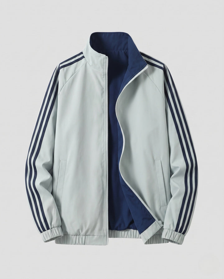 Unisex reversible sports jacket with reversible design, stand-up collar, full-length zipper, and distinctive sleeve stripes