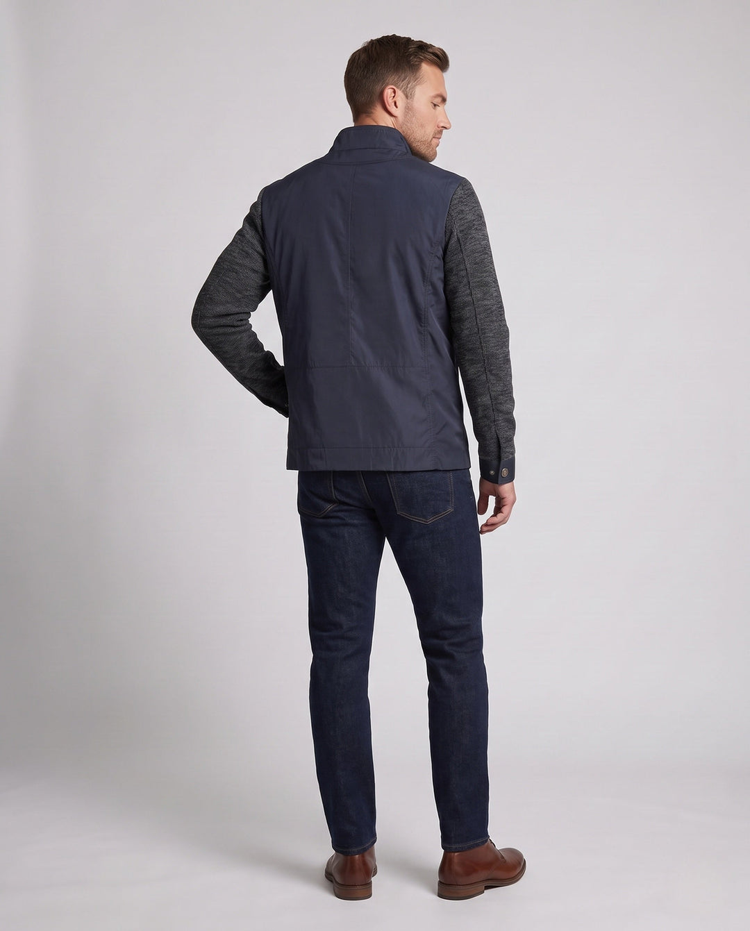 Men's hybrid jacket with faux leather front, quilted detail, and knit sleeves