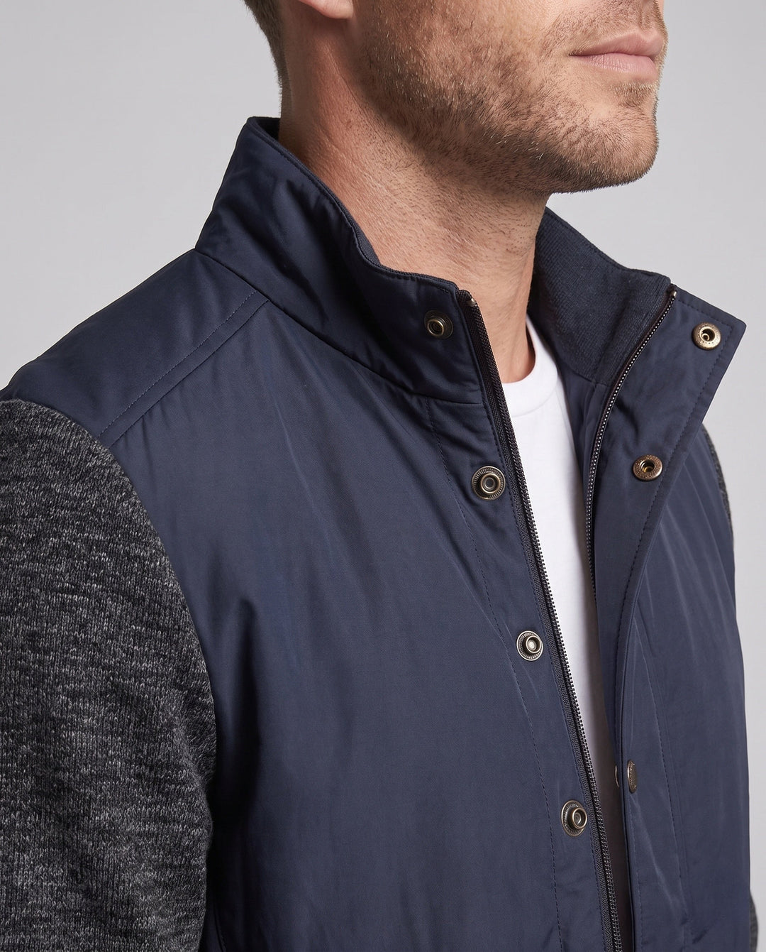 Men's hybrid jacket with faux leather front, quilted detail, and knit sleeves